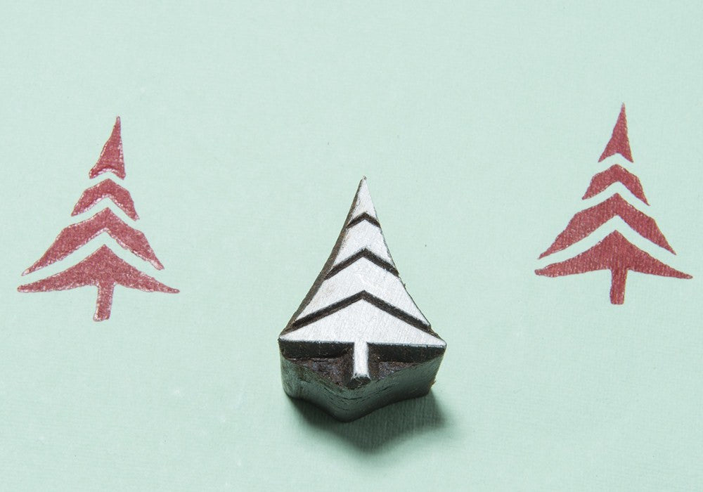 A small wooden printing block of a Christmas tree